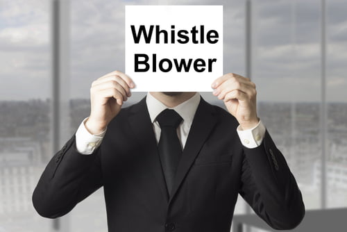 business man holding whistle blower sign over face.